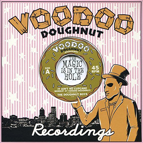 the album cover for Doughnut Boys & Pink Boxxes - It Ain't No Cupcake (Workin' at Voodoo) / Cheap
