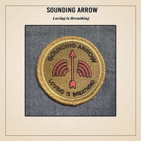 the album cover for Sounding Arrow - Loving Is Breathing